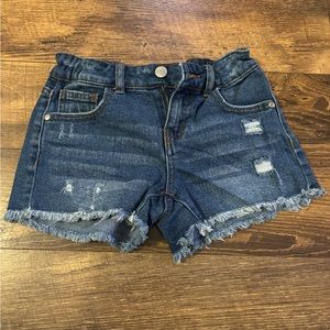 Distressed jean shorts with adjustable waist.